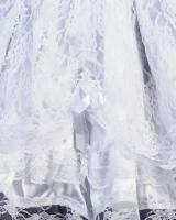 Jupe courte blanche avec dentelles et noeuds en ruban